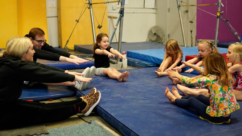 a group of people sitting on mats