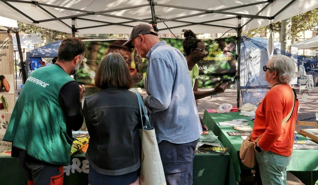 People at a greenpeace information booth